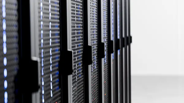 Server racks with blinking blue lights showing cloud computing infrastructure