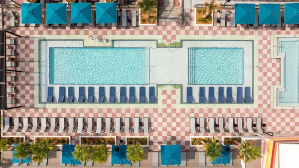 Aerial view of a rooftop swimming pool at Hub Tallahassee, a student housing development serving Florida State University.