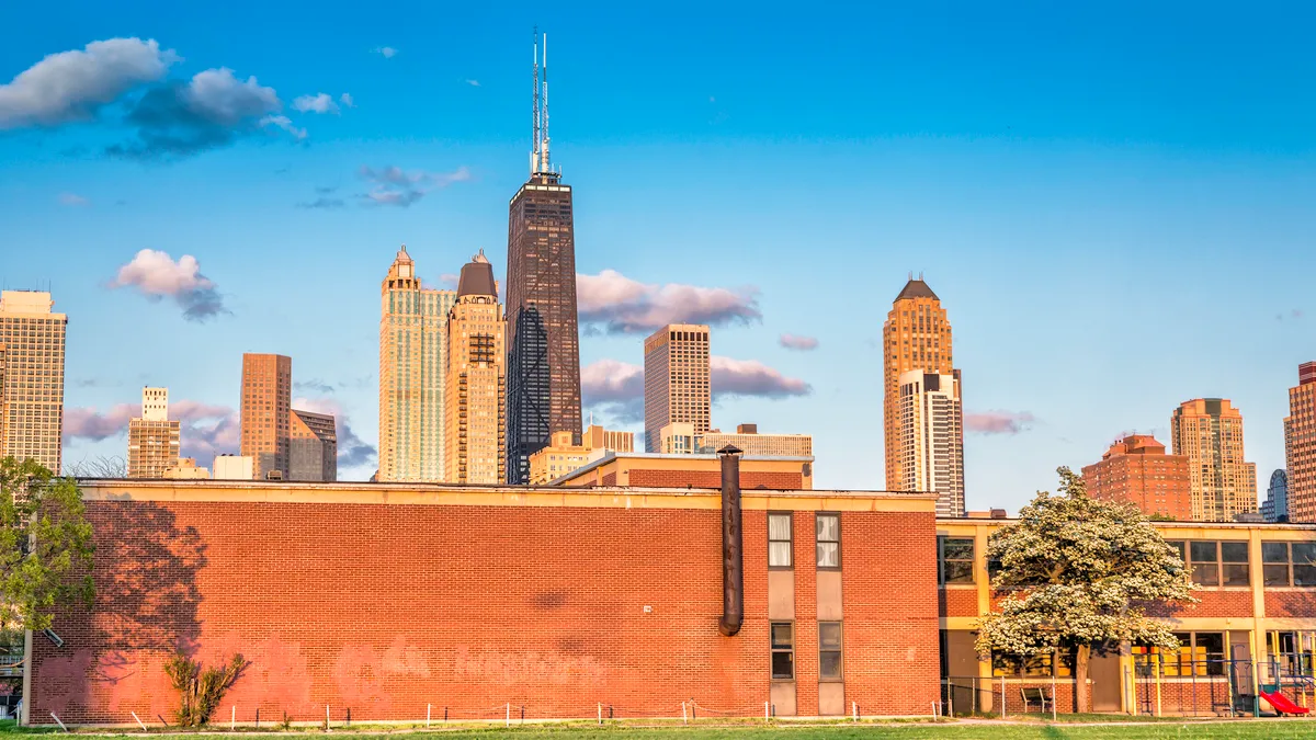 Chicago city skyline sits behind a school building.