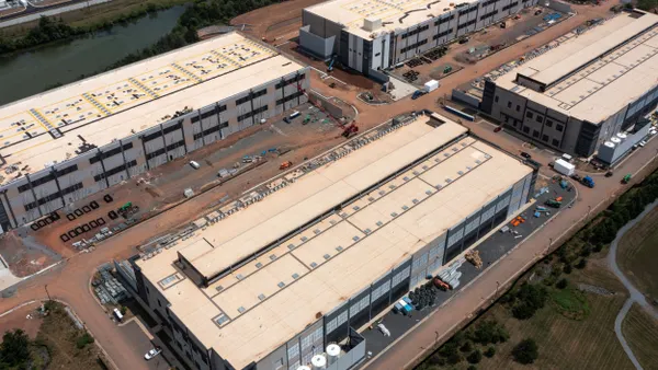 An aerial view of a cluster of large data centers.
