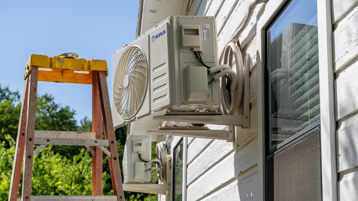 An AC unit sits next to an empty ladder.