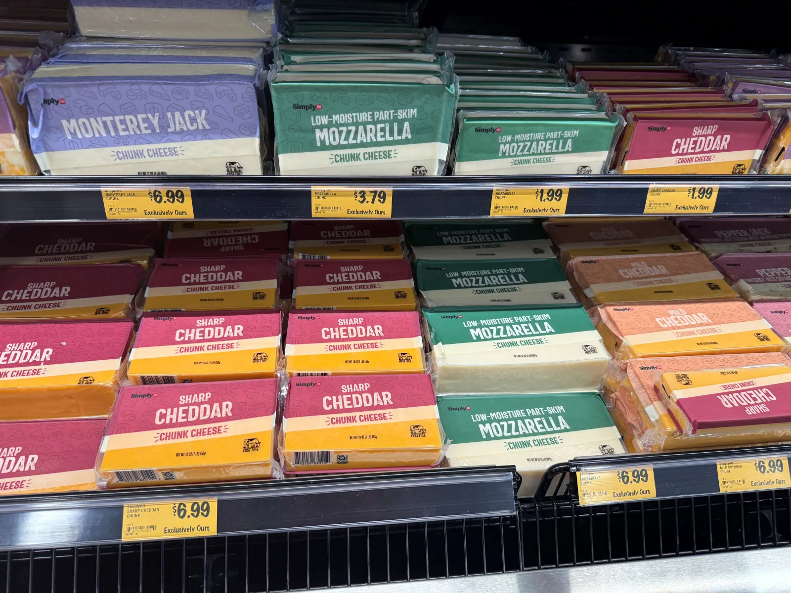 Blocks of cheese at a grocery store.