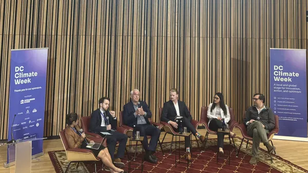 A panel of AI experts gather in an auditorium at Martin Luther King Library in Washington, D.C.