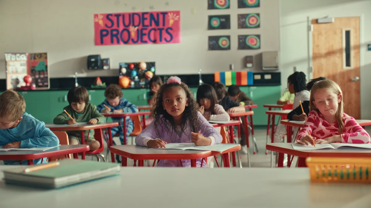 A student sits at a school desk in an back-to-school ad from Target