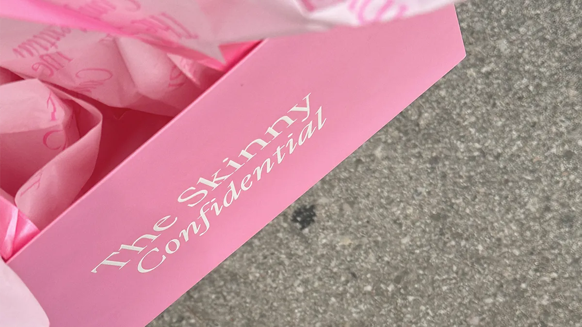 A Skinny Confidential shopping bag.