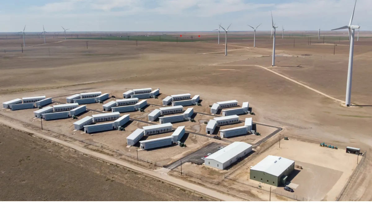 An aerial view of Soluna's Project Dorothy data center in Texas, with a row of windmills in the background.