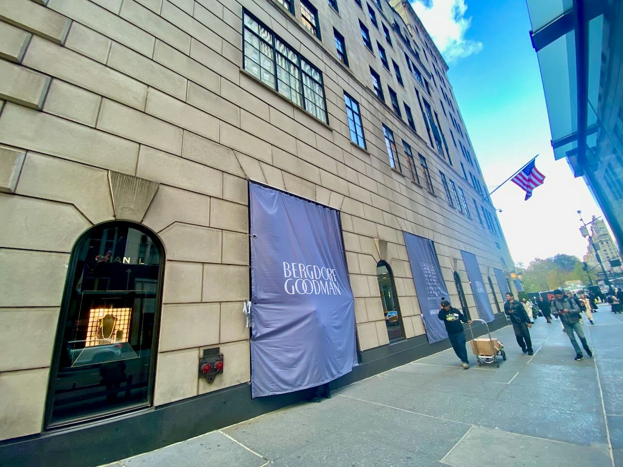 Someone working underneath the drapes covering an outside store window.