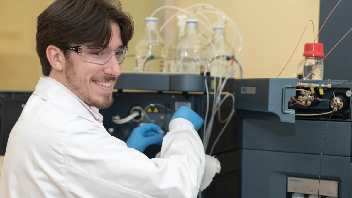 Scientist working in a lab and smiling