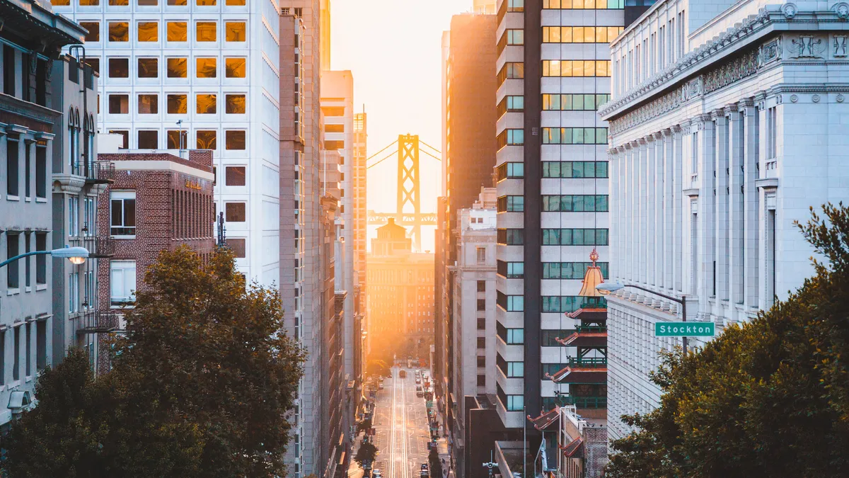 A view of commercial buildings on a street in downtown San Francisco, California at sunrise,