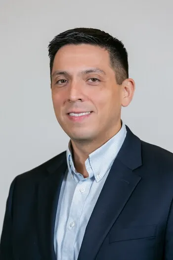 Headshot of Revlon COO Mario Rivera