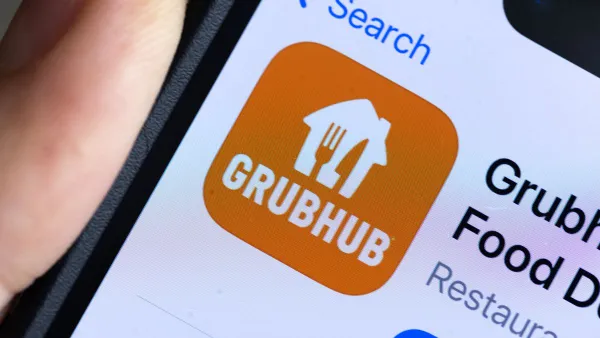 A zoomed in image of a smartphone with a on orange app square that says "Grubhub" in white.