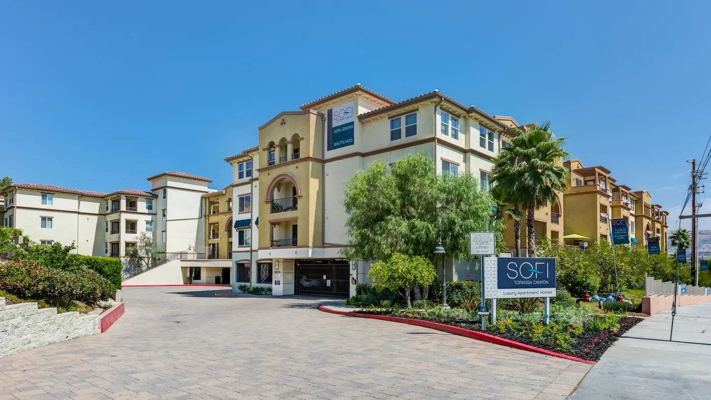 Brown four-story apartment community