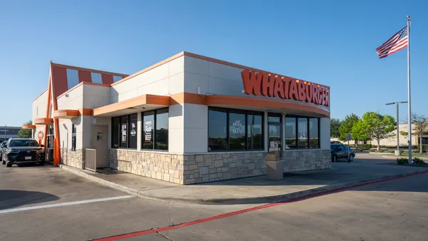 An exterior view of a whataburger restaurant including its drive-thru