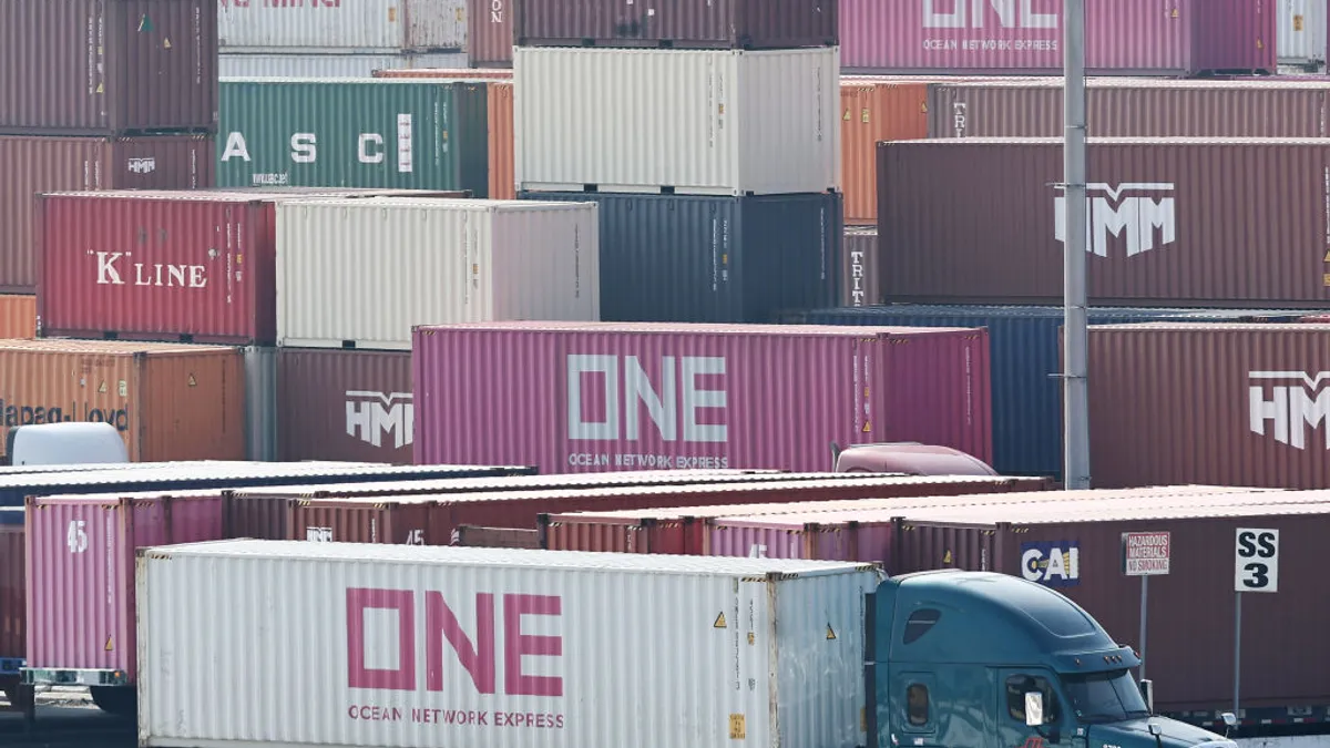 A truck drives inside a container terminal in Long Beach.