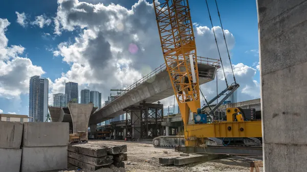 Heavy machinery and workers working on the construction of a new viaduct along the north of downtown Miami