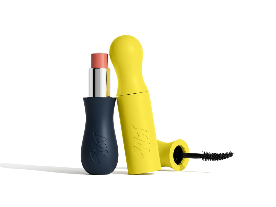 An uncapped tube of Tilt Beauty&#x27;s lip treatment with a yellow tube of its mascara leaning against it.