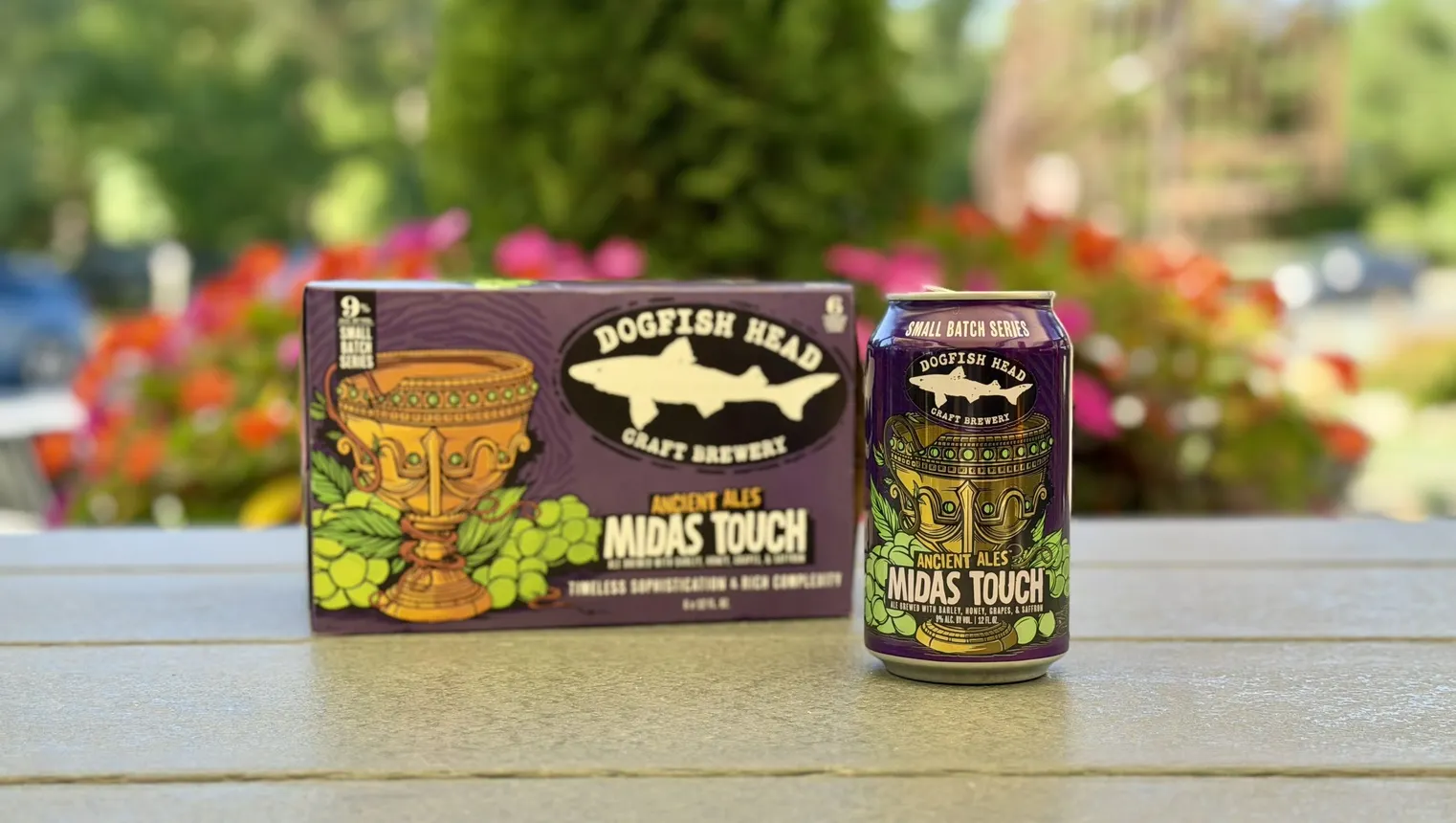 A case of Midas Touch beer is next to a can of the beer.