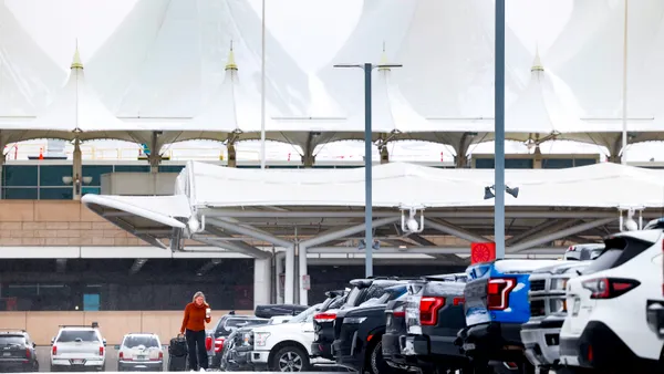 A woman walks to her car