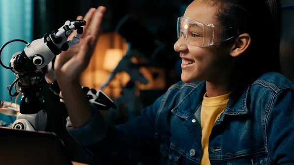 Young tech enthusiast smiles on camera