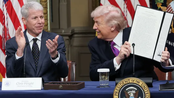 Two people holding up an document