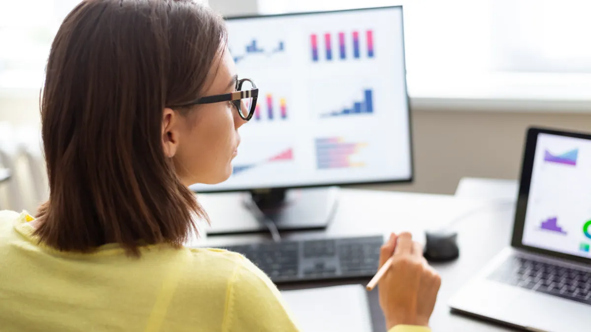 Woman looking at statistics on computer screen