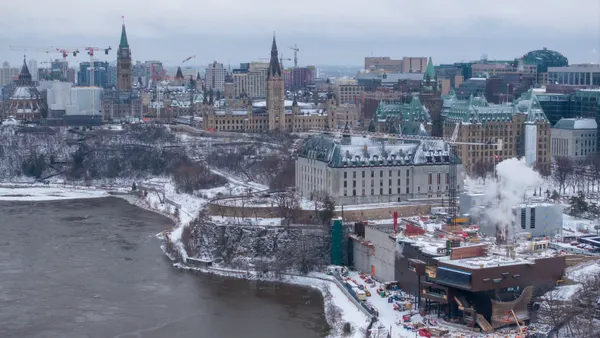 An aerial view of a snowy section of Ottawa filled with historic buildings.