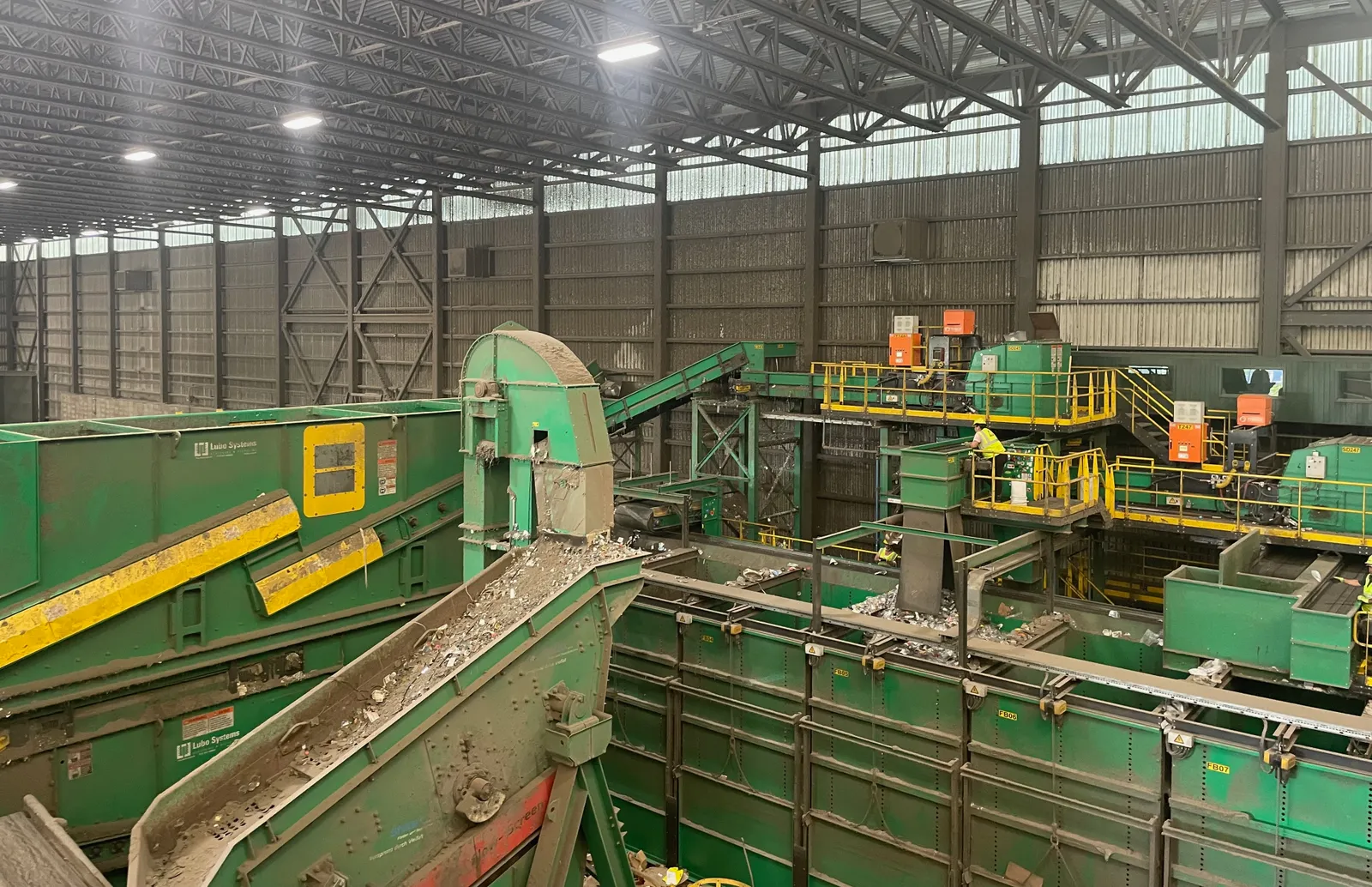 View of recycling facility, with employees sorting material