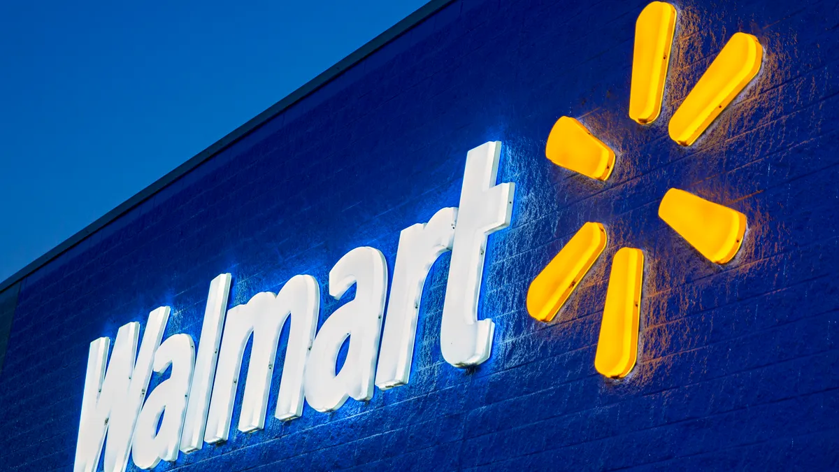 The exterior of a Walmart store at night