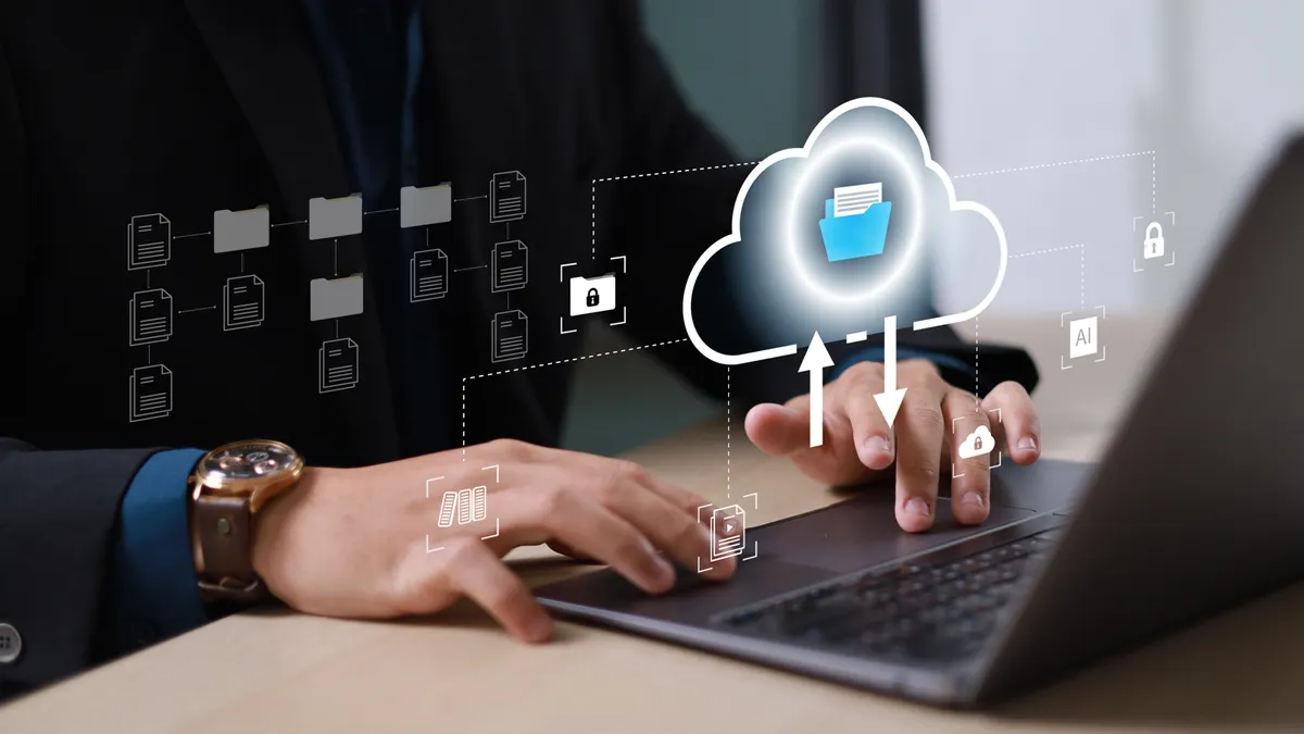 A person types on a laptop with a digital cloud icon above, signifying cloud storage. Arrows indicate data transfer, conveying a tech-focused theme.