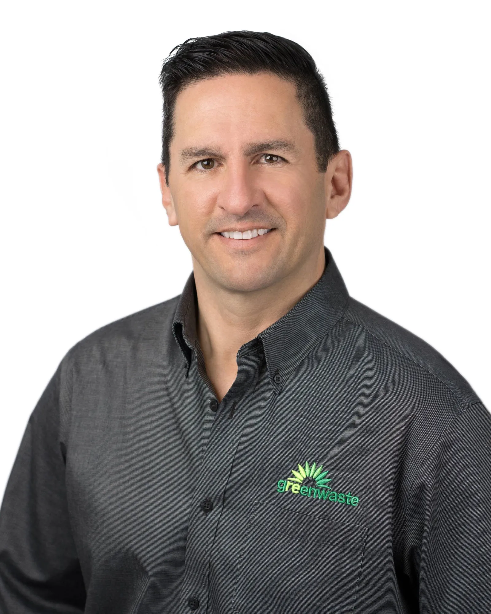 A man wearing a button-down shirt with the GreenWaste logo smiles in a portrait.