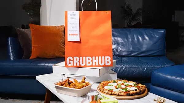 An image of an orange bag with Grubhub and pizza boxes.