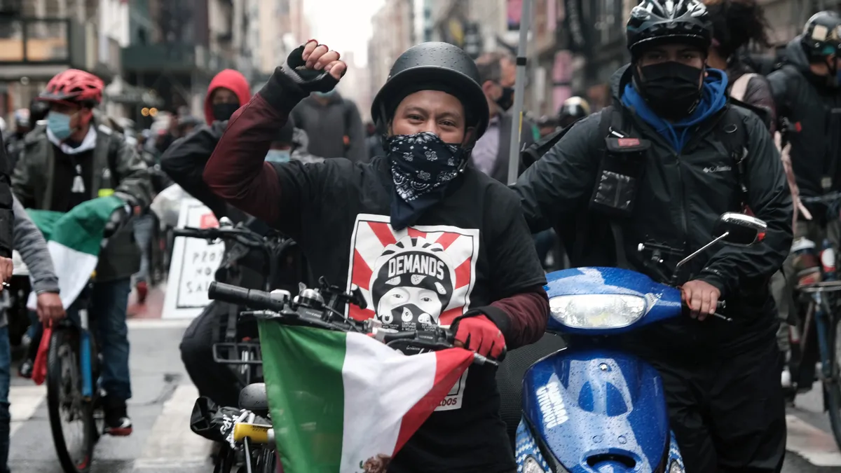 Delivery workers rally for higher pay and safer working conditions in New York City.