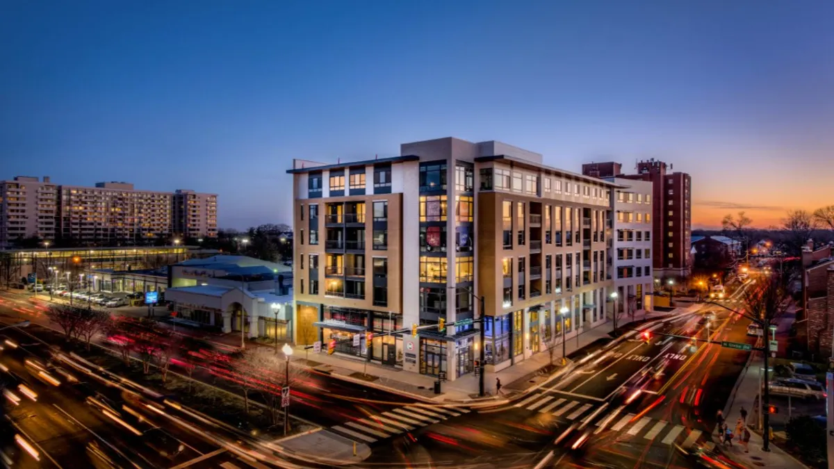 Aerial picture of a modern apartment property at dusk.
