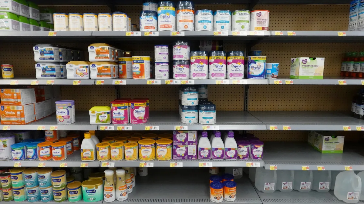 Shelves of baby formula in a store.