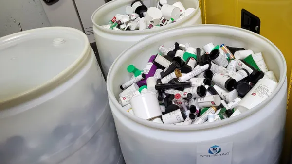 Large drums filled with multicolored plastic flakes.