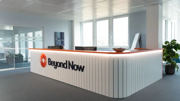 A technology company office lobby with the company name, Beyond Now, pictured on the reception desk.
