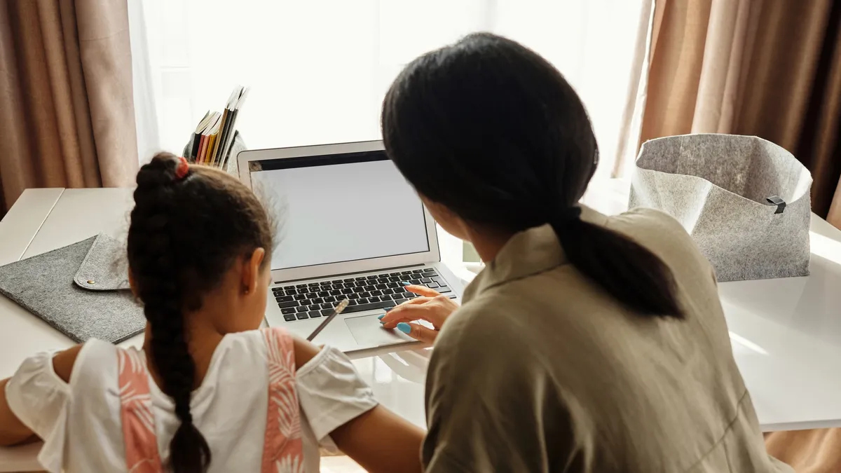 parent helps child with remote school