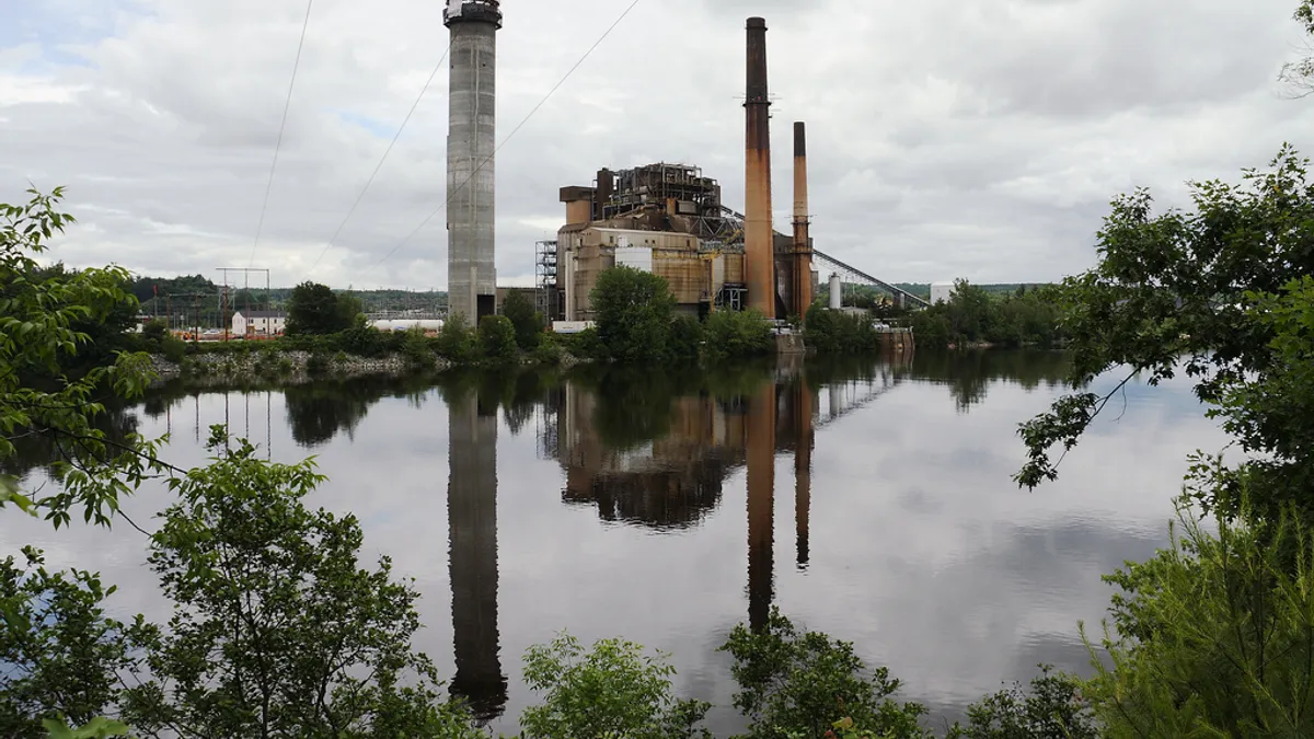 Merrimack Station reflected in river, with no smoke coming from the plant, on an overcast day.