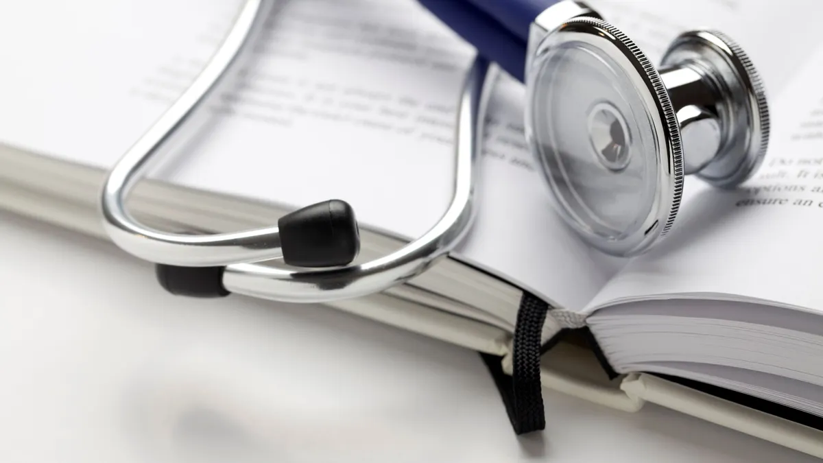 A stethoscope rests on a book.