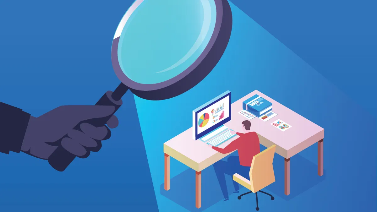 Businessman working under the surveillance of a magnifying glass