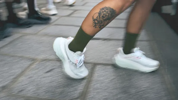 Saucony "Run as One" campaign imagery that includes a pair of white shoes.