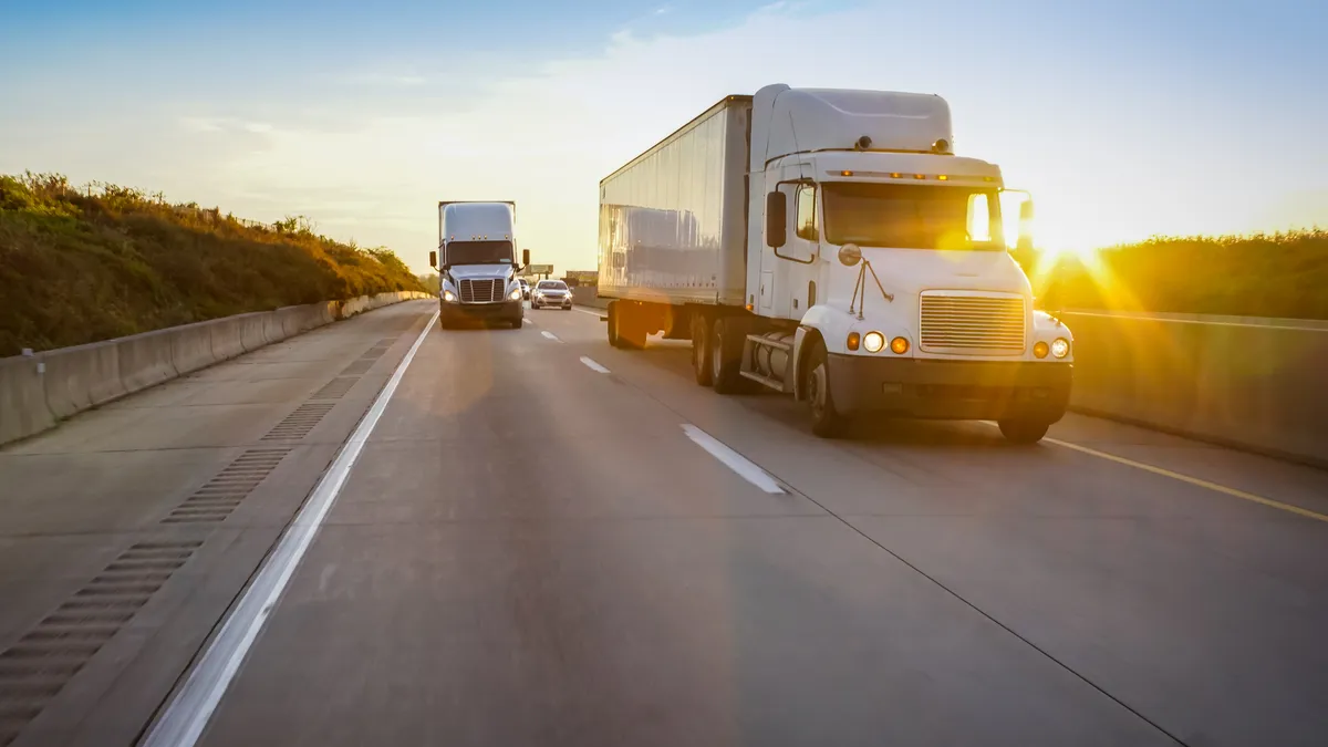 Tractor-trailers on a highway.