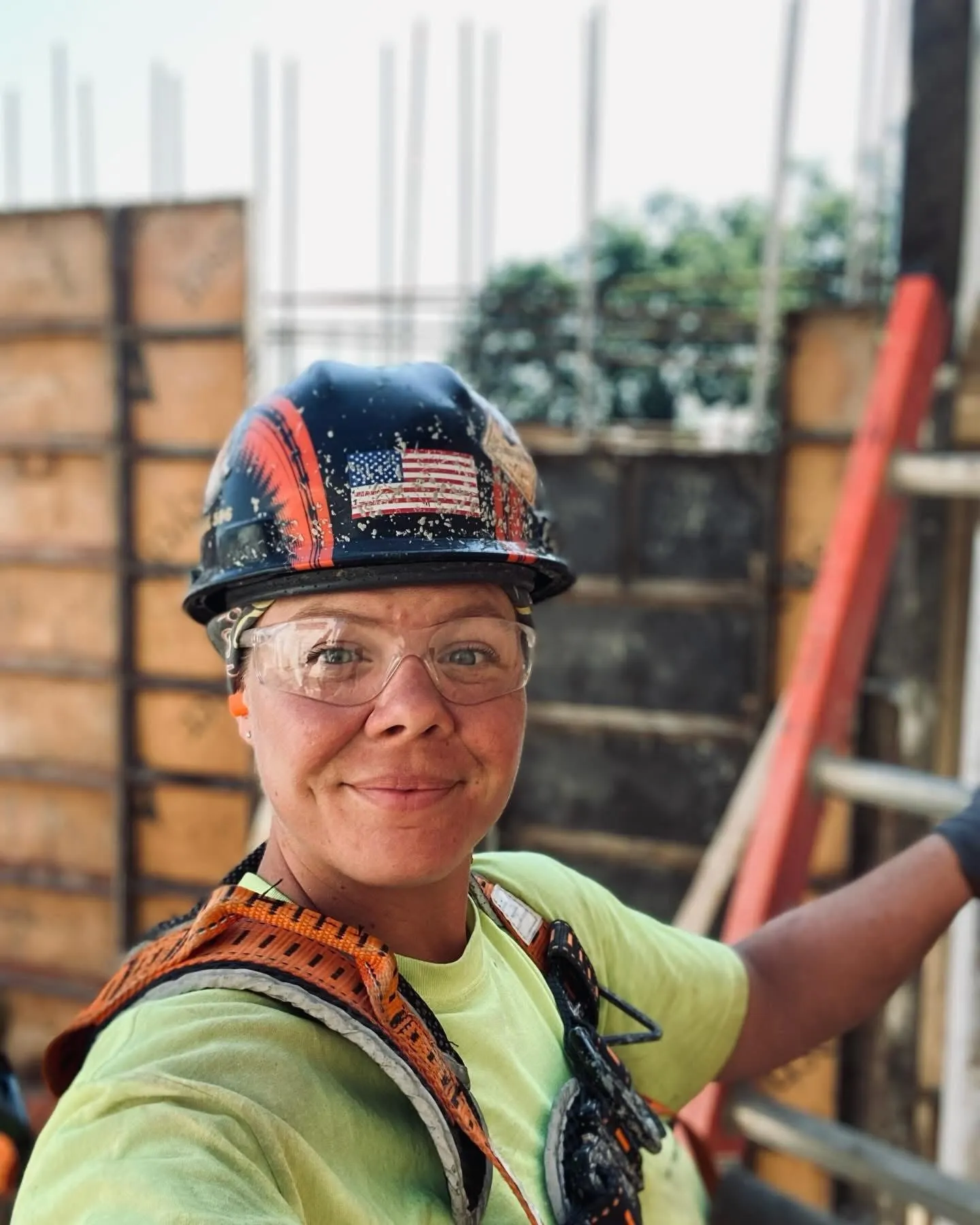 A woman in a hardhat poses for a photograph.