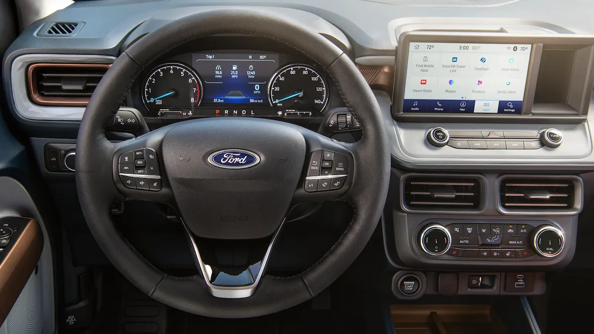 The driver side of a 2024 Ford Maverick pickup showing the steering wheel, instrument cluster and infotainment screen.