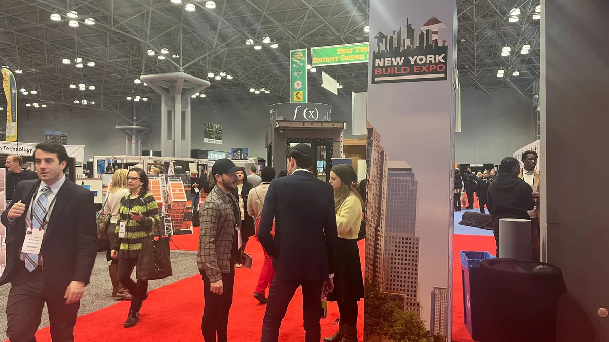 Attendees walk around the New York Build Expo conference floor.