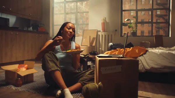 A young woman eats Ben's Original rice after moving in
