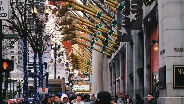 Trumpets decorating the side of a building in a city downtown.