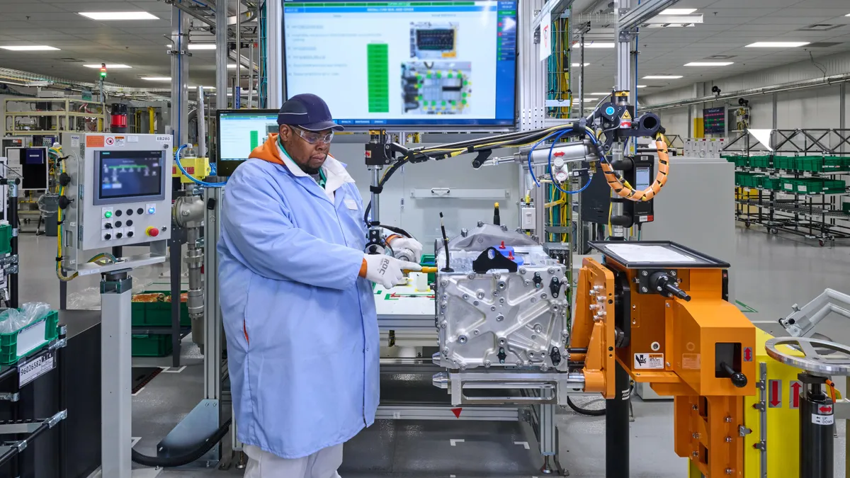 An employee assembles a fuel cell system at GM and Honda’s fuel cell joint venture plant.