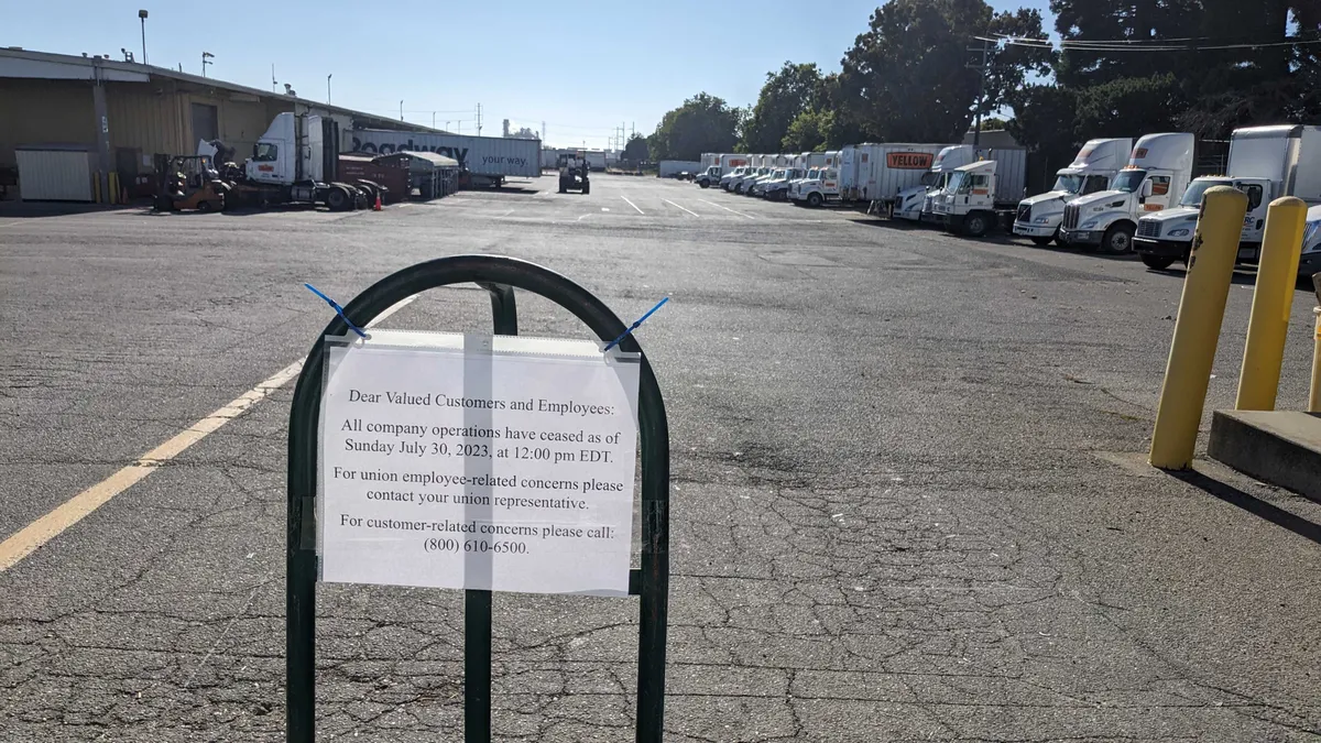 A notice attached to a dolly at a Yellow terminal in Hayward, California notifies customers and employees company operations have ceased as of noon Sunday.