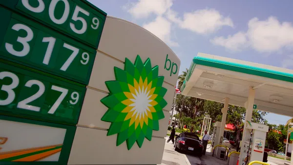 A BP sign displays prices at a gas station.